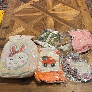 Backpack  with 5 packages of doll clothes